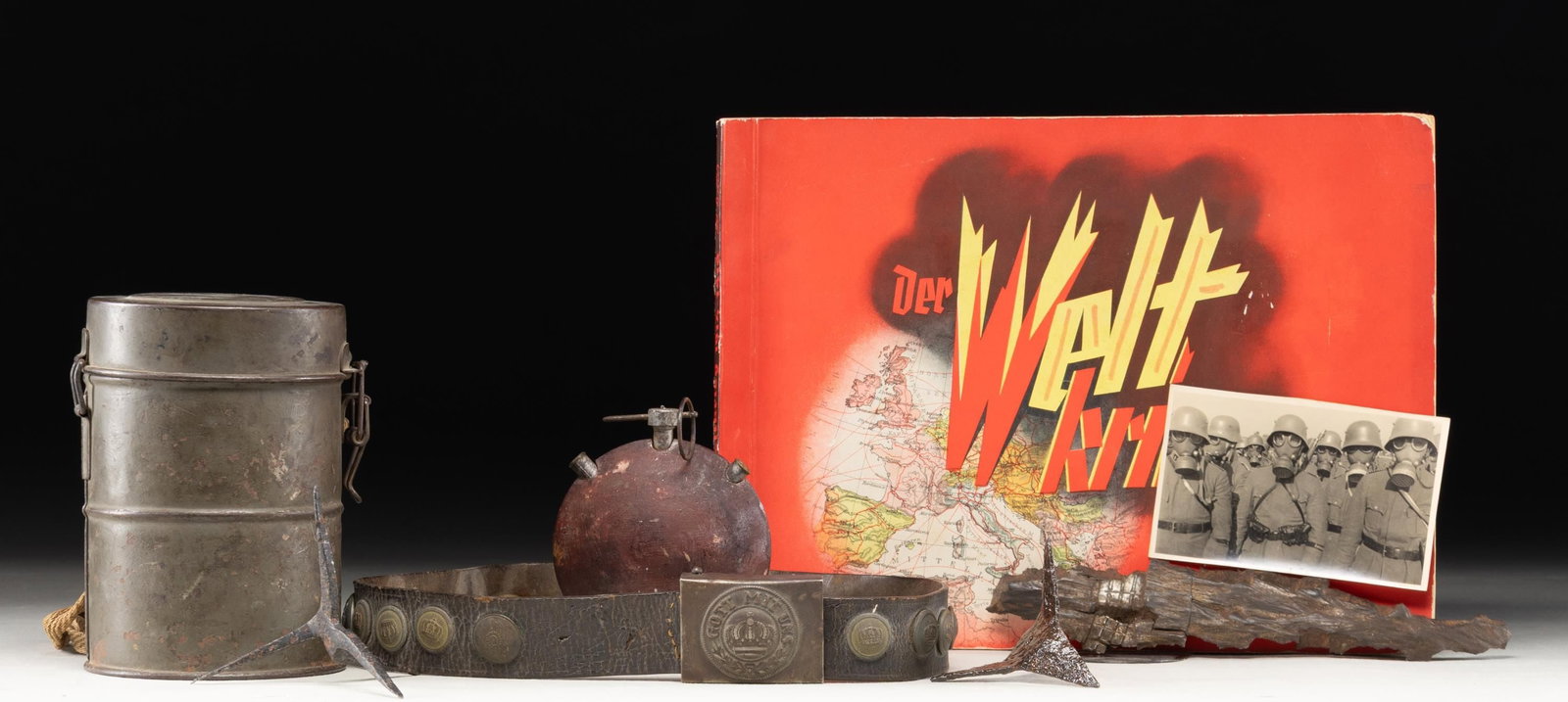 WWI GERMAN MILITARIA GROUPING.: An interesting militaria grouping from WWI includes (2) caltrops reportedly found at Verdun & Ypres, a WWI German gas mask in its storage can, a dewatted German turtle grenade, Imperial German hate be