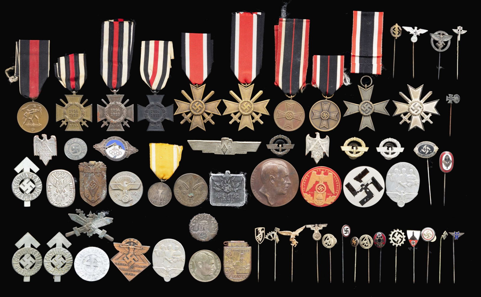 WWII GERMAN MEDALS, STICKPINS, TINNIES AND MORE.: This fine lot of WWII German items include 1 Sudetenland Medal with ribbon. / 1 War Merit Cross 1st Class with swords. / 1 War Merit Cross 2nd class without swords with ribbon. / 2 War Merit Medals wi