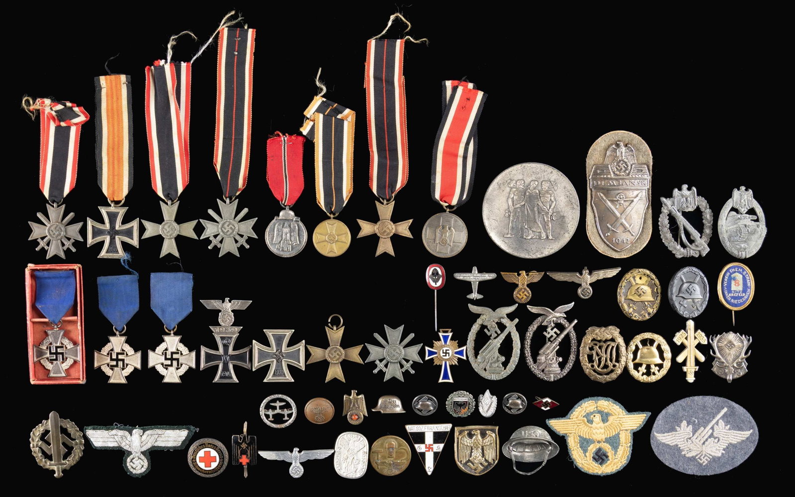 COLLECTION OF WWII GERMAN MEDALS, BADGES AND MORE.: This large and varied lot includes 1 Large desk medal with 3 individuals on one side and the words "FUR LANGJAHRE GE MITARBEIT IM DIENSTE DER PFALZISCHEN WIRTSCHAFT", 2 War Merit Crosses with swords a