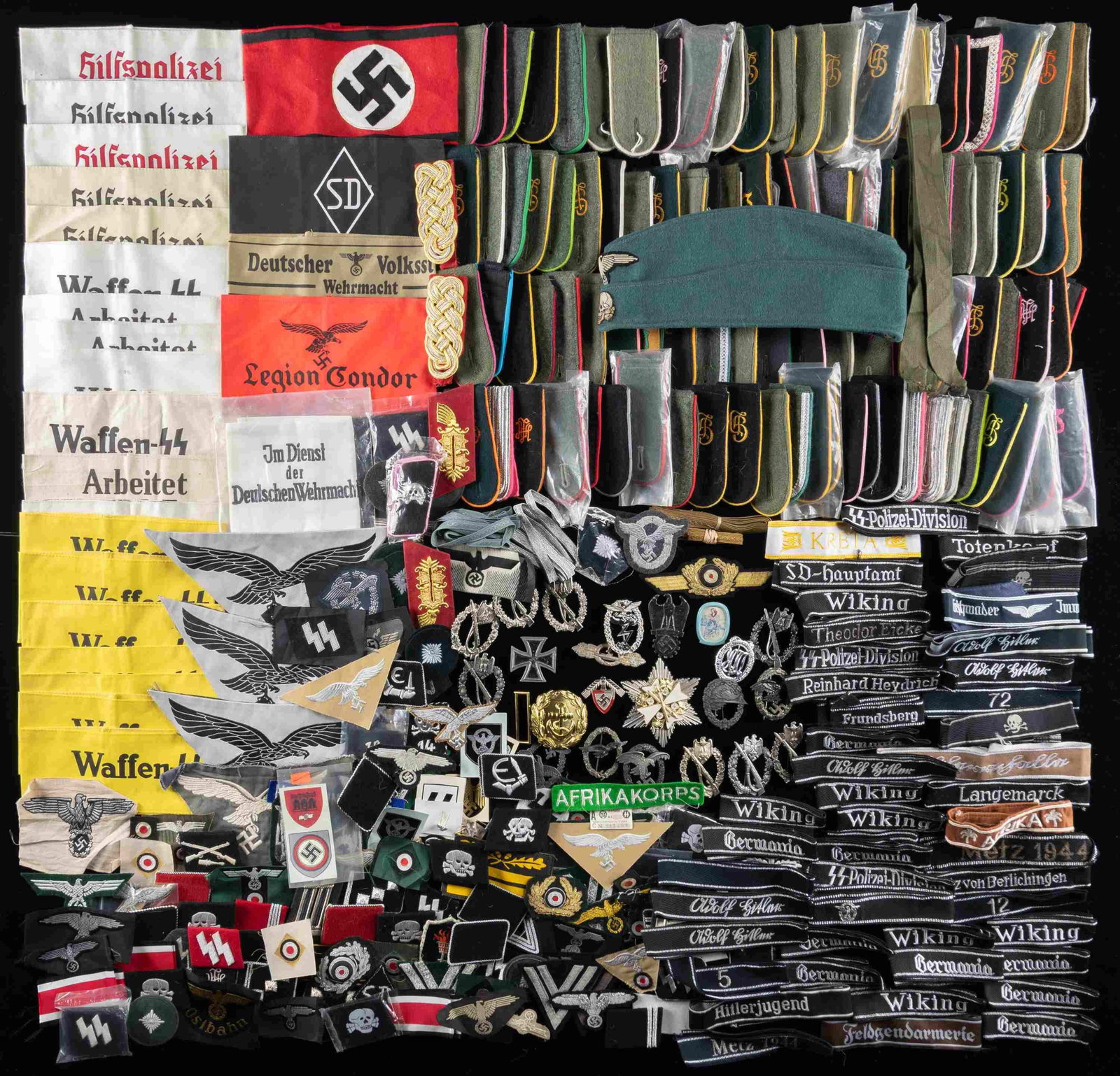 IMMENSE GARGANTUAN GROUP OF WWII STYLE GERMAN: CLOTH WITH OTHER MILITARIA. This lot needs to be seen to be believed! There are hundreds and hundreds of pieces of good quality reproduction WWII German cloth and even some badges and more. Items incl