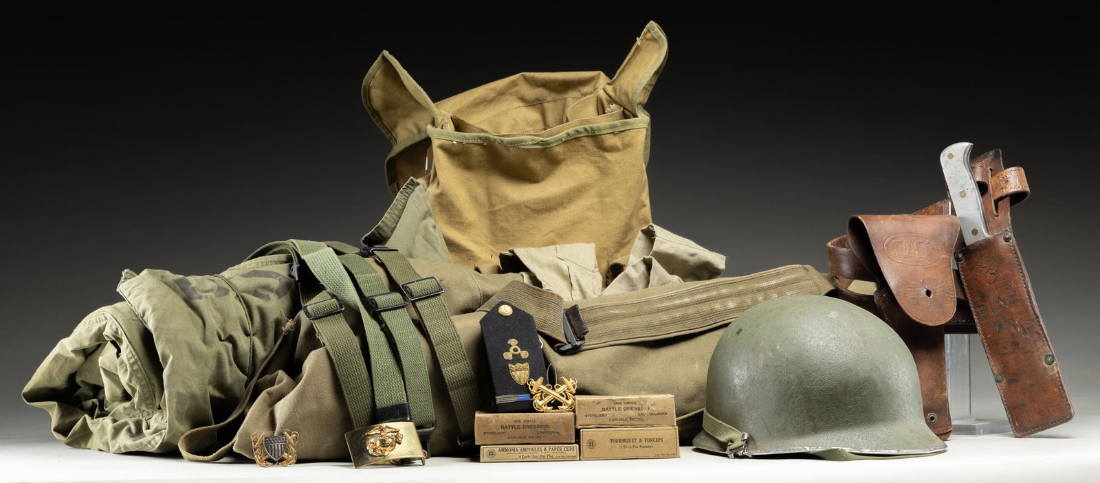US MILITARY GEAR.: Lot includes, but not limited to: Brown leather belt with 1918, model 1911 holster & East Bros. Air Force Survival 13" knife with sheath.USMC bag with boxes of battle dressings.M1 Helmet with liner.4