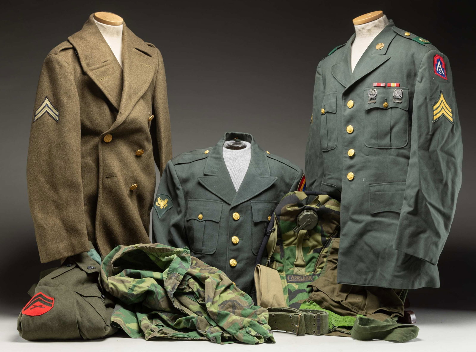 GROUPING OF U.S. ARMY UNIFORMS.: 1) WWII U.S. Army overcoat of a Corporal in the Supreme Headquarters Allied Expeditionary Force.2) Vietnam era U.S.M.C. service coat belonging to a Corporal.3) Vietnam era U.S. Army dress jacket belon