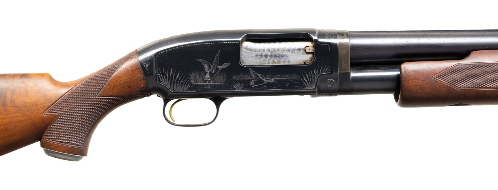 WINCHESTER MODEL 12 HEAVY DUCK PIGEON GRADE PUMP: SHOTGUN. Cal. 12 ga. 3". S# 1553734. Bbl. 30" w/ solid rib & steel bead. Fixed full choke. Action has No.2 factory engraving apparently done by one of the Kusmit brothers. Right waterfowl scene featur