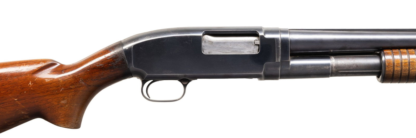 FACTORY SOLID RIB WINCHESTER M12 SLIDE ACTION: SHOTGUN. Cal 12ga 2 3/4". S# 997603. Mfg. 1942. Bbl. 30" Full choke. Steel bead front sight. Walnut stock set with no buttplate. CONDITION: overall poor+. 70% thinning orig blue with moderate oxidatio