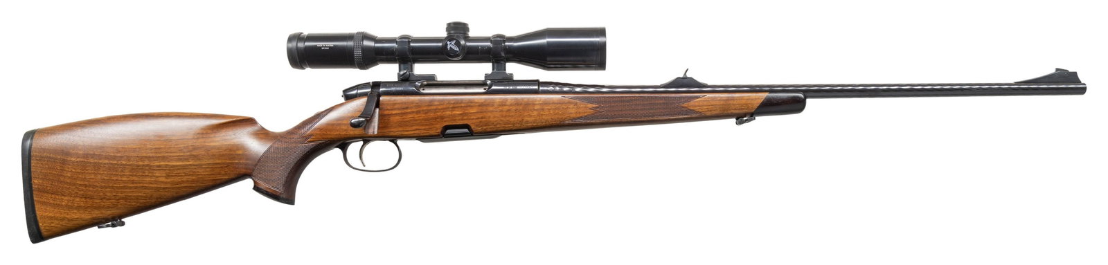 STEYR CLASSIC AMERICAN BOLT ACTION RIFLE.: Cal. 243 Win. S# 1023645. 24" hammer forged bbl. Left side is GSI import marked. Ramp mounted blade front with fixed U-notch rear sight. Swarovski Habitch 30mm 2.2-9x42 scope with European 4 post reti