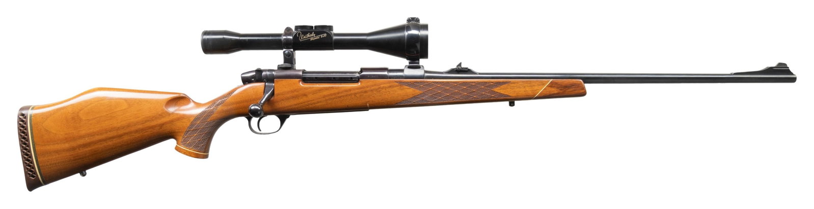 GERMAN WEATHERBY MARK V DELUXE BOLT ACTION RIFLE.: Cal. 300 WBY Magnum. S# P18401. 24"ramp mounted blade front bbl with folding leaf rear sight. Weatherby Imperial 6x62 gloss finished scope with standard crosshairs. Monte Carlo cheekpiece walnut stock