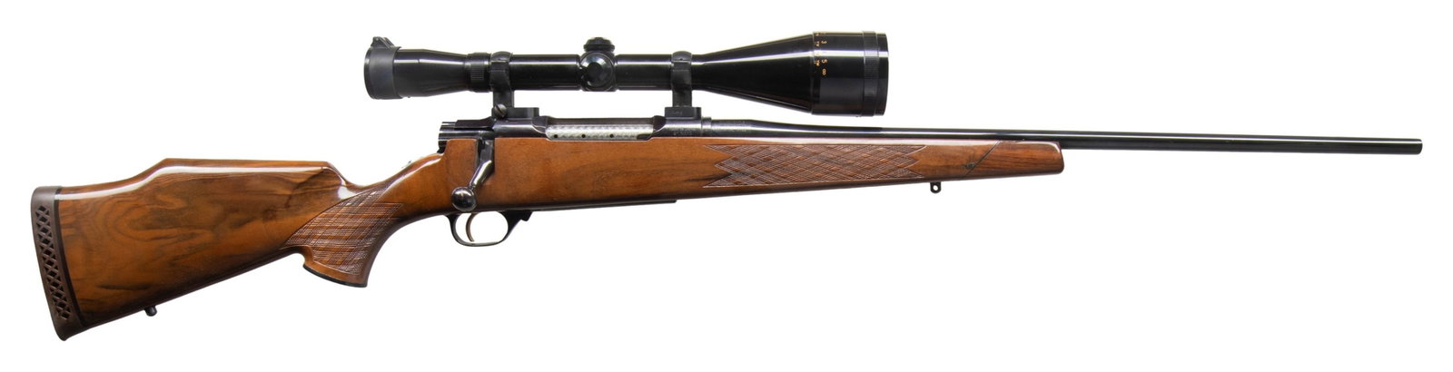NIKKO GOLDEN EAGLE MODEL 7000 BOLT ACTI0N RIFLE.: Cal. 300 Win Mag. S# NO23223. 24" bbl without sights. Redfield Illuminator 30mm tube 3-12x56 AO gloss finished scope with duplex reticle. Burris 2 pc bases. Rear locking 5 lug bolt with jeweled body. 