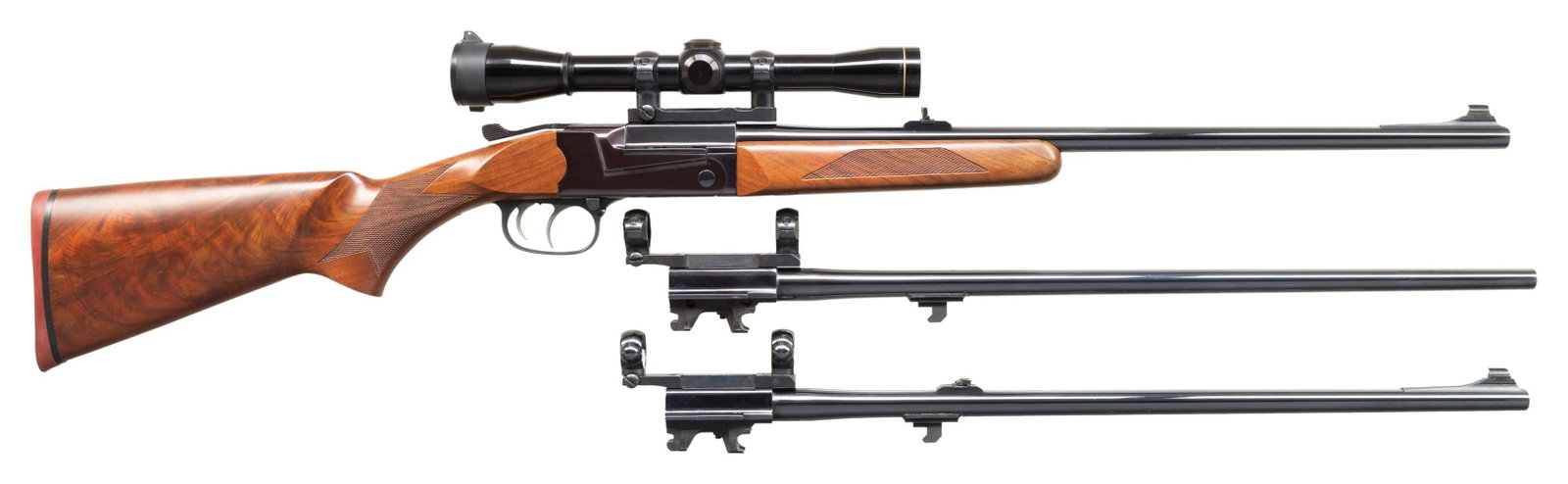 THOMPSON/CENTER TCR 83 SINGLE SHOT RIFLE WITH 2: EXTRA SETS OF BARRELS. Cal. 30-06. S# 10315. 23" bbl with ramp mounted bead front & folding leaf rear sight. Leupold M8-4x32 gloss finished scope with duplex reticle on a 1 pc base. Top lever breakope