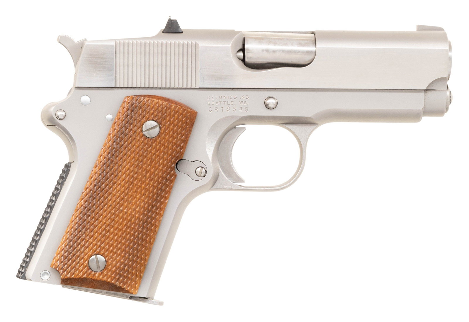 DETONICS MKVI SEMI AUTO PISTOL.: Cal. 45 ACP. S# CR19548. Bbl. 3 1/2". Blade front sight. Blued square notch rear sight. Stainless frame with Seattle, WA address. Brightly finished slide. Checkered hardwood grips. MAGS: 1-6 rd.