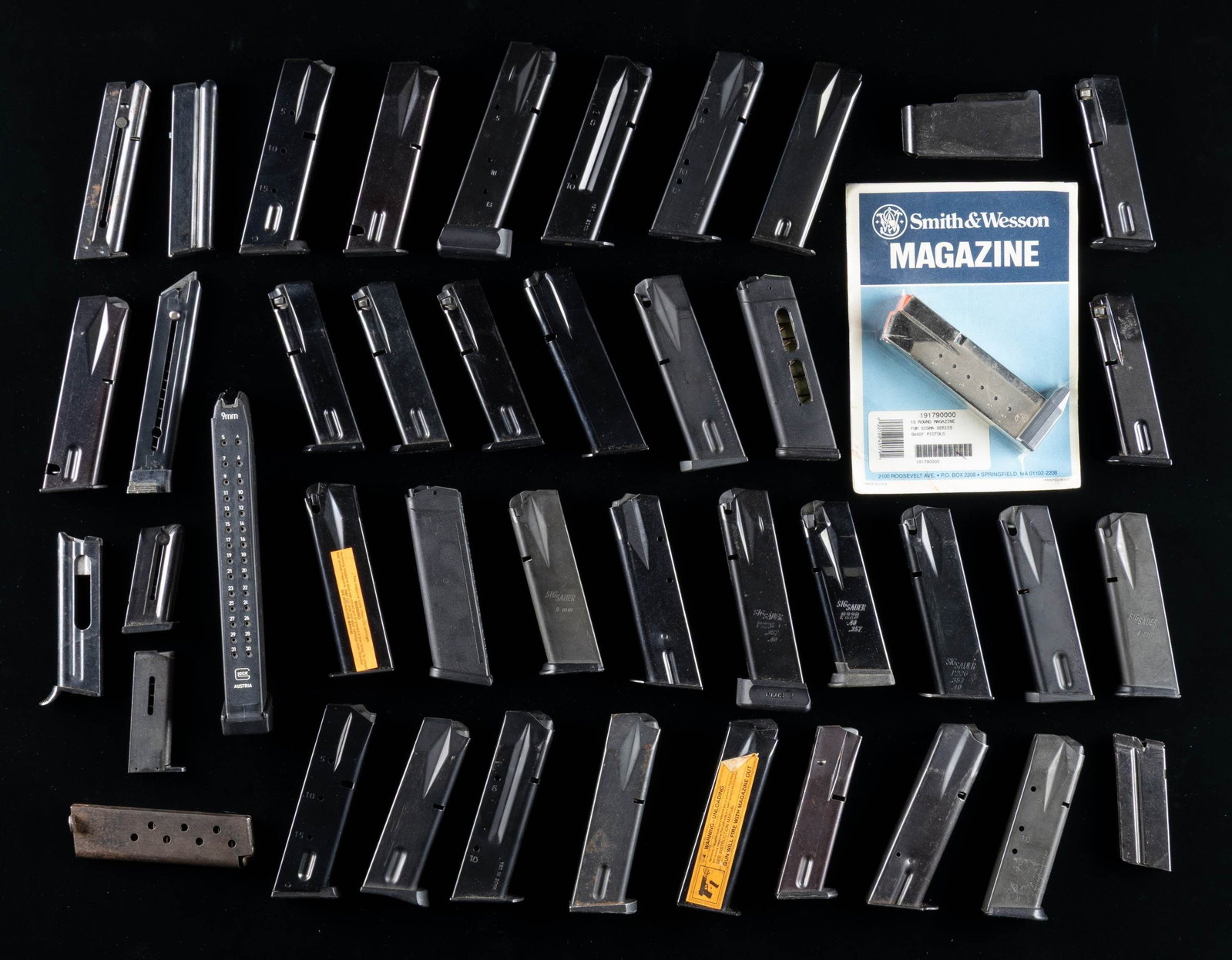 GROUPING OF 40 MOSTLY PISTOL MAGS.: 1- Glock 31-rd 9mm.1- Glock 17-rd 9 mm.1- Glock 17-rd 9mm.1- S&W 10-rd M41 mag.1- Marlin 25N 10-rd mag.1- Ruger Mark I 9-rd.1- Beretta 948 22LR 8-rd.1- Astra M600 mag.4- CZ 75 15-rd mags.2- EAA