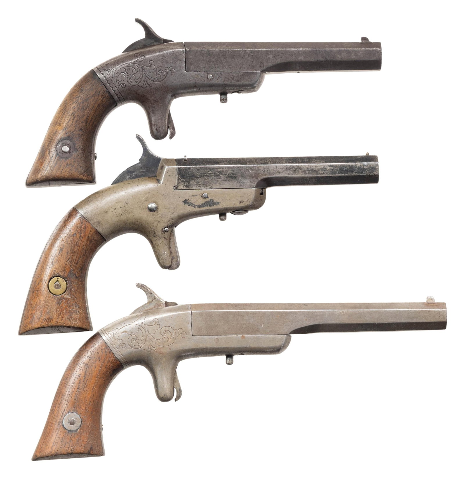 THREE BACON MFG. CO. SINGLE SHOT PISTOLS.: Estimated total of 2,400 mfg. early to mid 1860s. 1) Small Frame with flush recoil shield. Cal. 32 RF. S#797. 5" octagon bbl. with dovetailed blade sight. Spur trigger iron frame has sprays of scroll