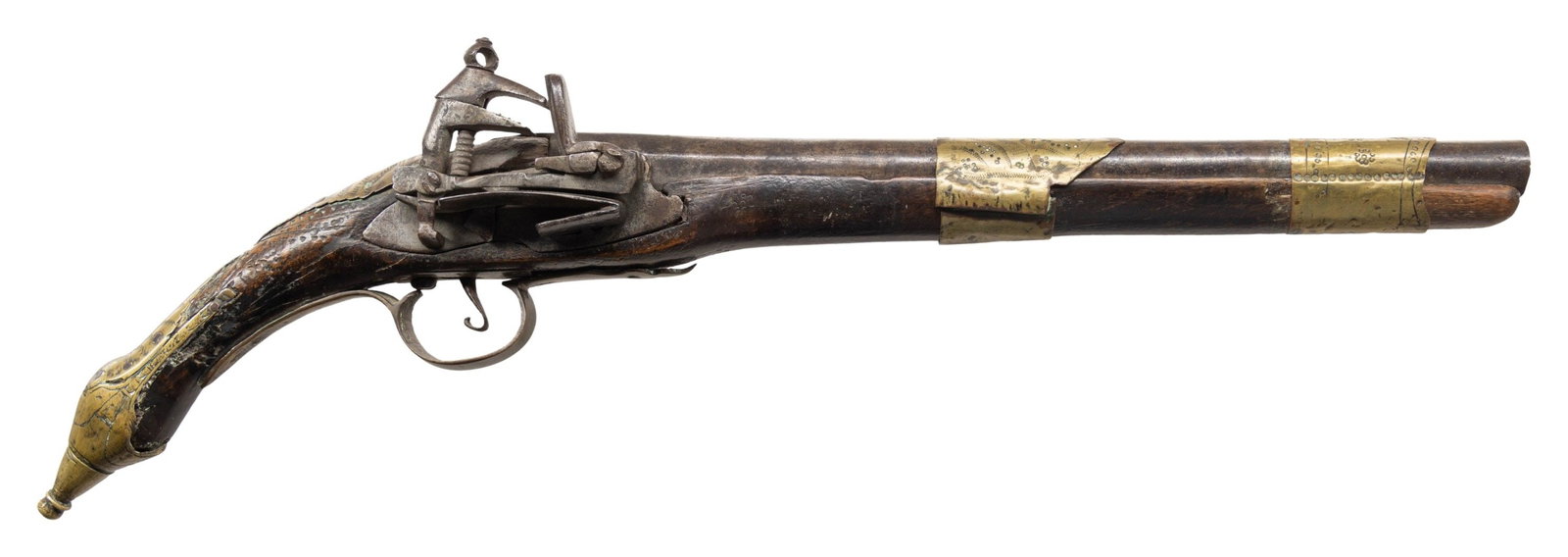 MID EASTERN MIQUELET PISTOL.: Cal. 54. Bbl 10". Brass mounts. Hardwood stock with traces of decorative carving. Crude construction with decorative accents. CONDITION: shows numerous repairs and wood loss. Dents and handling marks