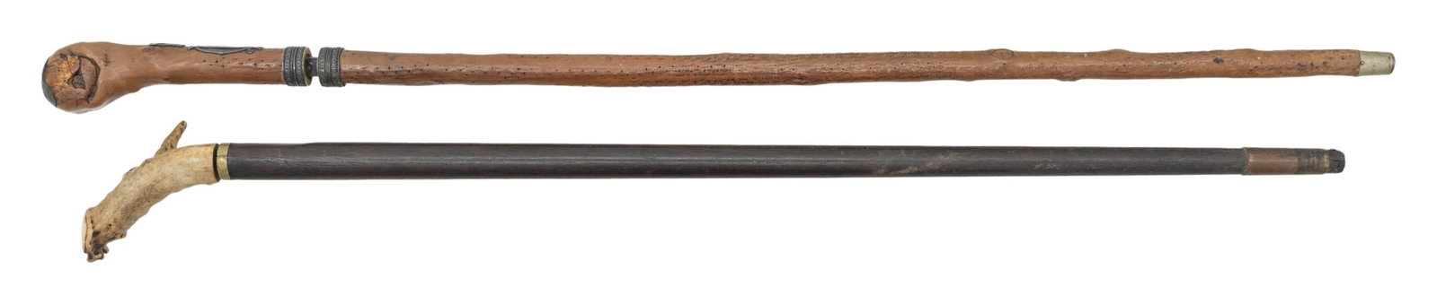 TWO VINTAGE SWORD CANES.: 35.5" wood body with burled knob, concealed 27" blue & gold "TOLEDO" marked blade. The handle is silver mounted with crown over pierced monogram. Second is 33" overall, stag handled with 11" sturdy da