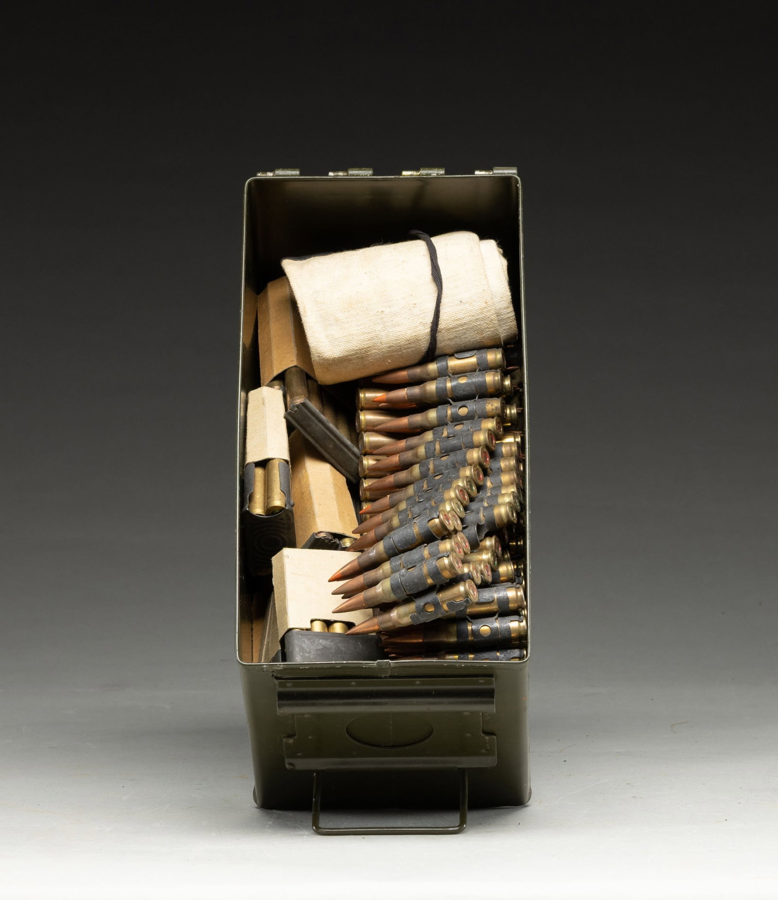 GROUPING OF MILITARY 30-06 AND 7.62 NATO: AMMUNITION. Lot contains both cloth and metal machine gun belts, cloth bandoliers and clips for 1903 Springfields and M1 Garand rifles. Cloth machine gun belt loaded with 55+ rounds of VC 45 ball ammu