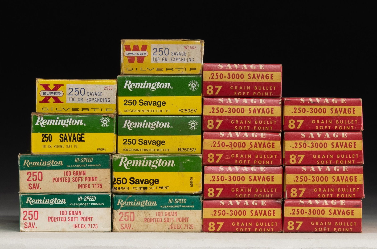 15 BOXES OF 250 SAVAGE AMMO AND SOME FIRED BRASS.: 9 Very nice boxes of Savage brand 250-3000 ammo having 87 grain soft point bullets. / 4 very good Remington green-yellow boxes of 250 Savage with 100 grain soft point bullets. / 2 Winchester yellow bo