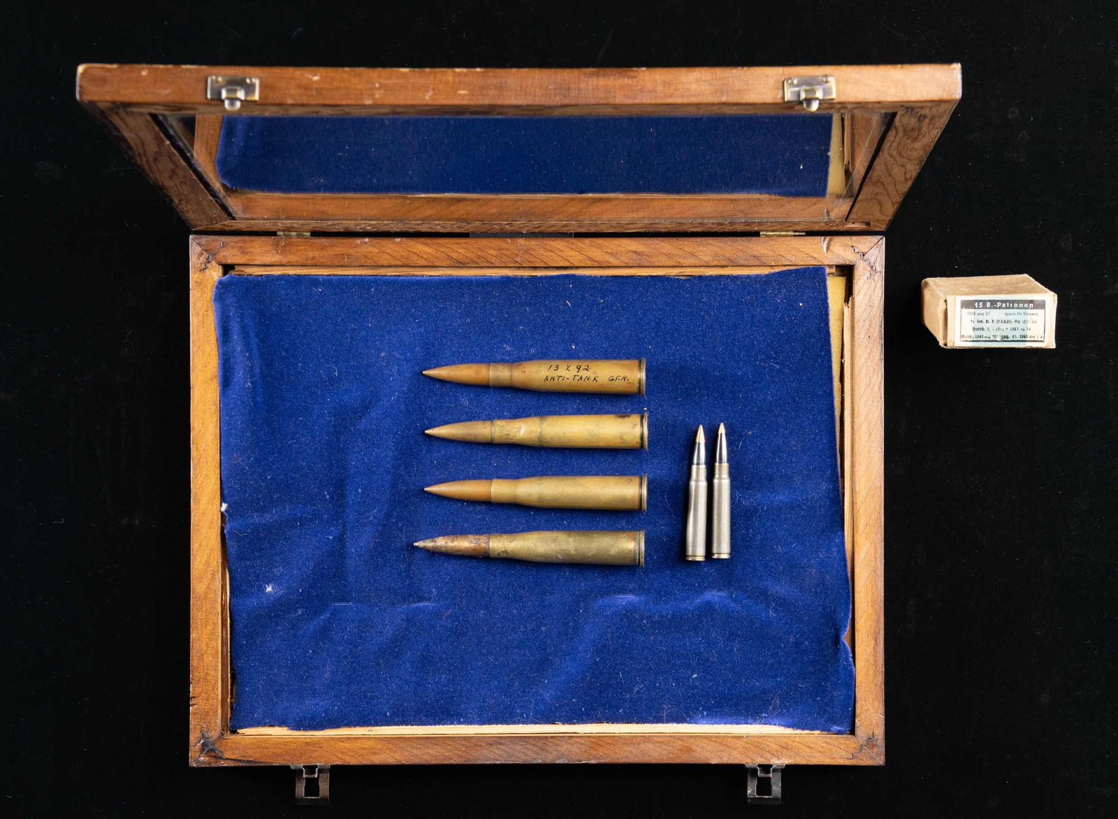 LOT OF DESIRABLE GERMAN MILITARY AMMO.: This lot consists of the following: 1) Four rds. of 13.2mm TUF (Tank Gewehr) ammo. All dated 1918 & made by Polte. One rd. has powder still in it & others appear to empty. CONDITION: one rd. has ink w