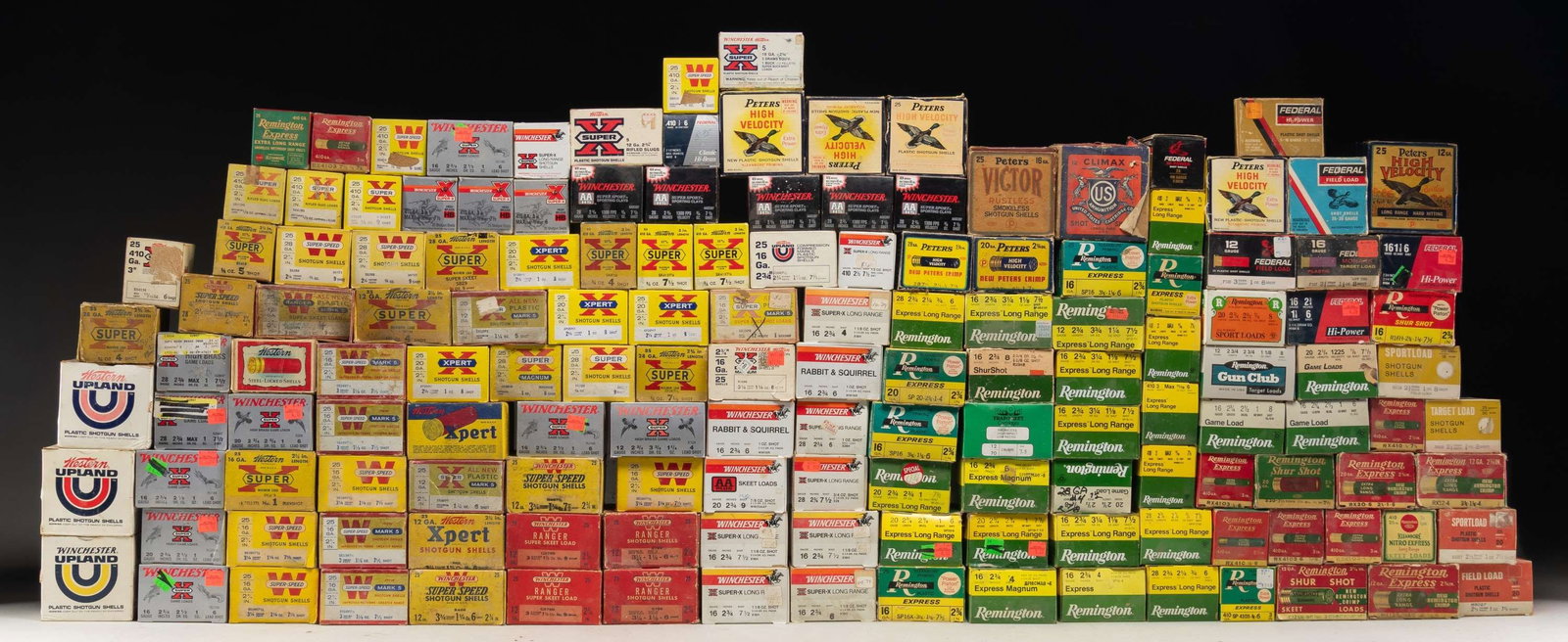 LARGE GROUPING OF VINTAGE AND MODERN SHOTGUN: AMMUNITION. Contains a very wide variety of gauges, shell lengths, shot sizes and manufacturers. Shells are both paper and plastic. Boxes are predominantly 25 round. (12 GAUGE): 13 full boxes and 10 p