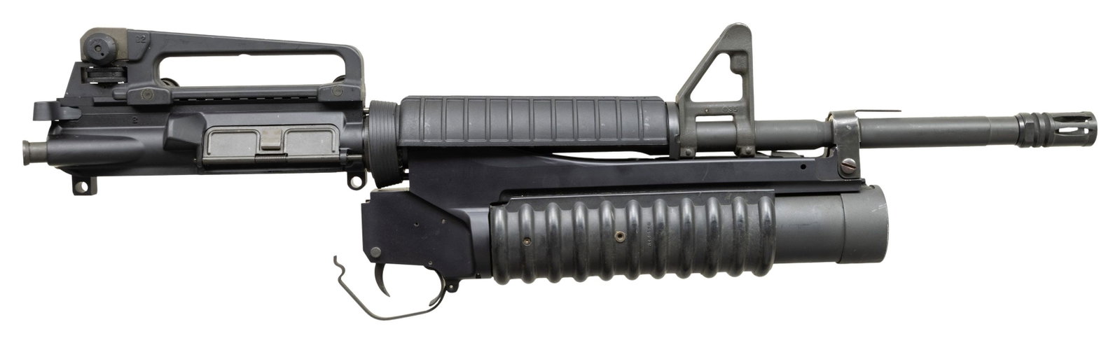SHIVAK (SAW) 40MM M203 GRENADE LAUNCHER ON CARBINE: BARRELED UPPER RECEIVER. Cal. 40mm. S# 1146LF. Bbl. 9.25". The iconic slide action, single shot 40 millimeter grenade launcher that has been burned into screens from both military coverage and