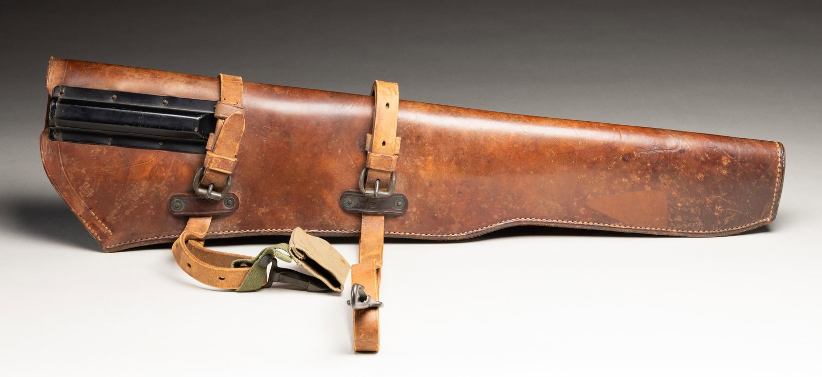 U.S. WWII BOYT M1 GARAND RIFLE SCABBARD.: Brown leather rifle scabbard designed to accept the 'then new M1 Garand rifle'. The scabbard has a prominent black finished metal receptacle on the outside to protect the slide handle of the rifle. Sc