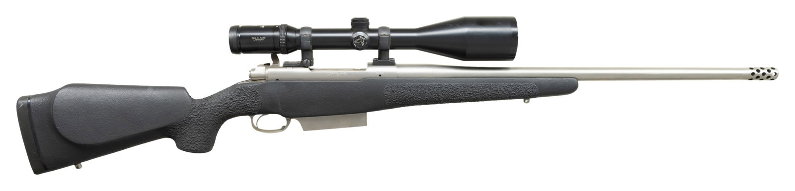 LEFT HAND DAKOTA 76 BOLT RIFLE WITH SCOPE.: Cal. 338 Win mag. S# 0432L. The 21-1/2" heavy weight stainless steel barrel fitted with 2" muzzle brake is devoid of sights and has caliber engraved at rear. Standard Dakota 76 action with Dakota info