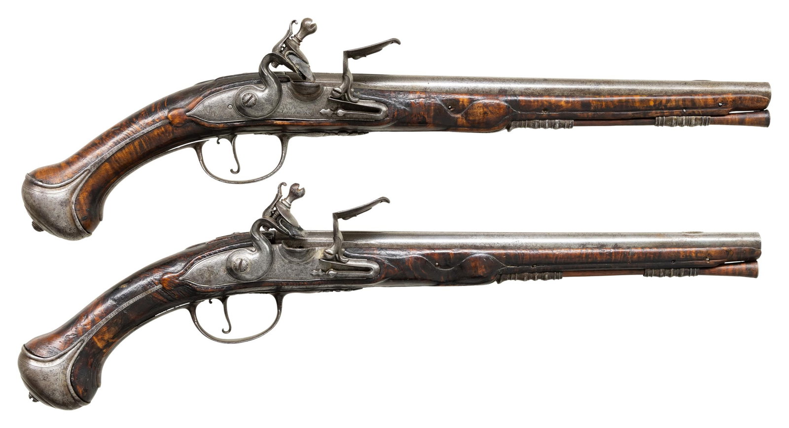 ELEGANT PAIR OF CIRCA 1730 FRENCH OFFICERS: FLINTLOCK PISTOLS. Cal. 54. NSN. 19.5" overall, 12.5" ribbed tapered barrels, Engraved pointed tail locks signed "De Lugre Angers". Angers was home to several 17th century and early 18th century gun m