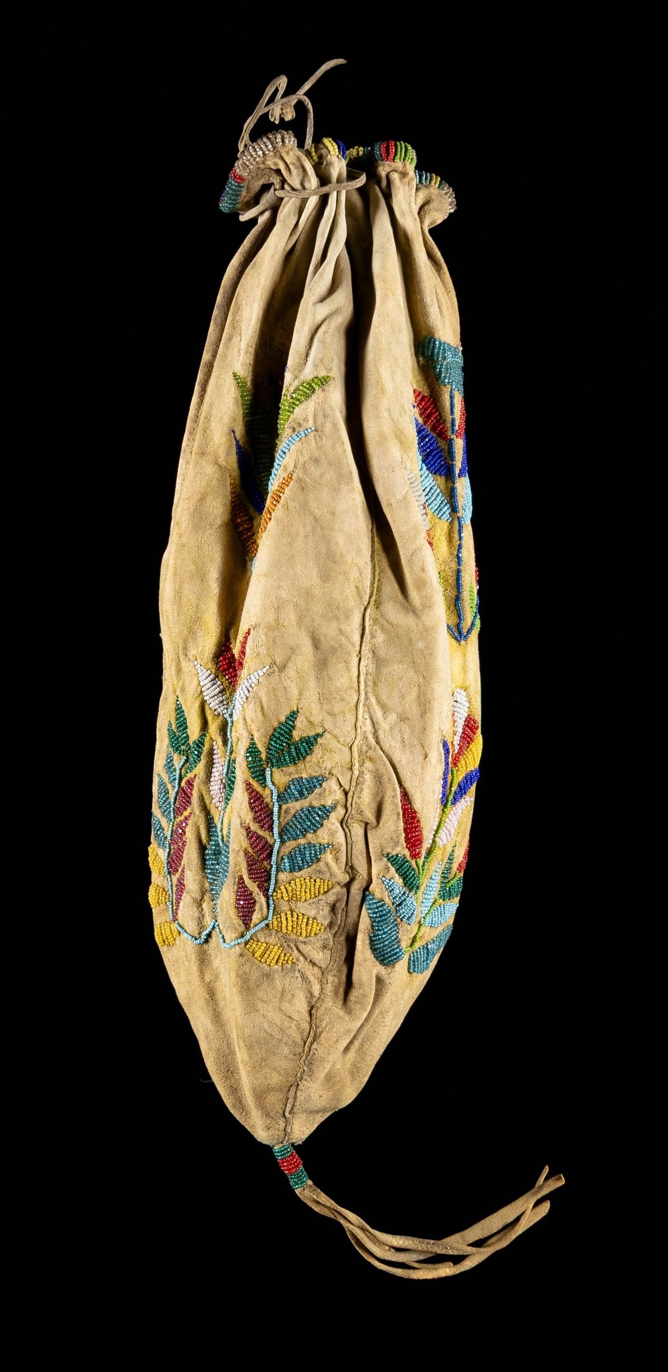 NATIVE AMERICAN BEAD DECORATED DITTY BAG.: 15" overall with small beaded drop, 7" beaded throat, geometric floral design, fine palette of reds, white, clear, blues, greens, and yellow beads sinew sewn. CONDITION: very good overall, of the 6 5"