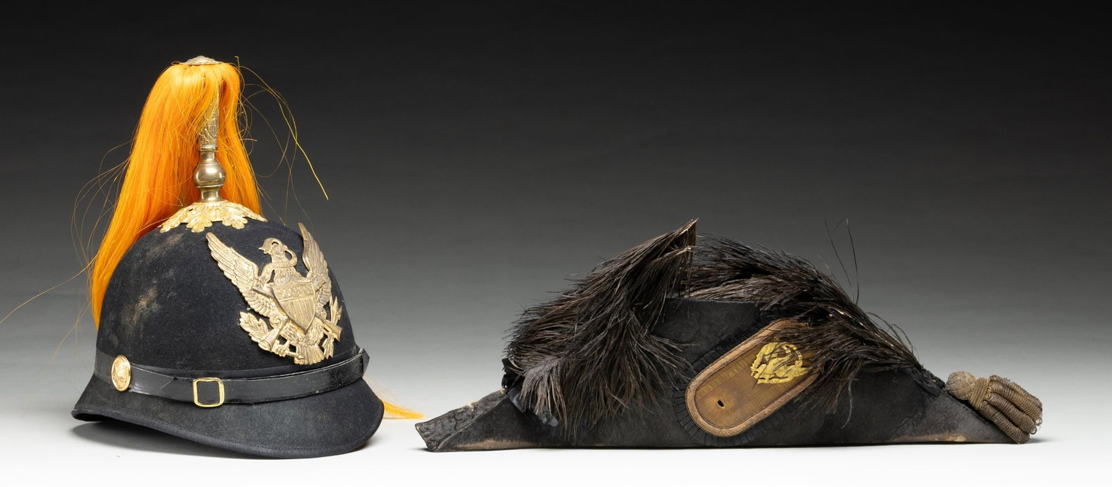 US M1872 CHAPEAU DE BRAS & US M1881 CAVALRY HELMET: 1) US M1872 Army officer's chapeau de bras made of beaver felt with one remaining gold bullion tassel at the rear. The left side has a bullion 4 1/2" escutcheon with an M1872 chapeau eagle and an