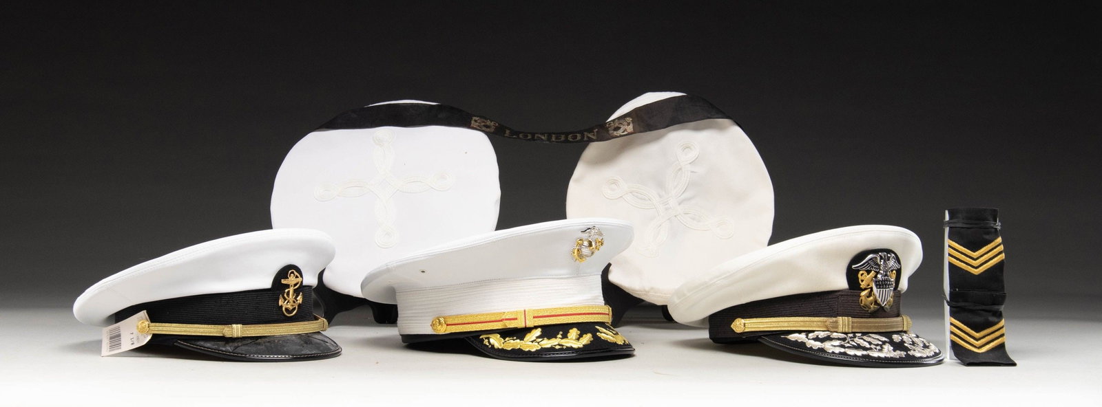 3 US NAVY AND US MARINE CORPS OFFICER HATS & MORE.: This lot includes 1 / USN white midshipman's visor cap from the US Naval Academy. 1 / USN officer's white visor cap with double rows of silver bullion "scrambled eggs" on the visor. 1/ USMC officer's