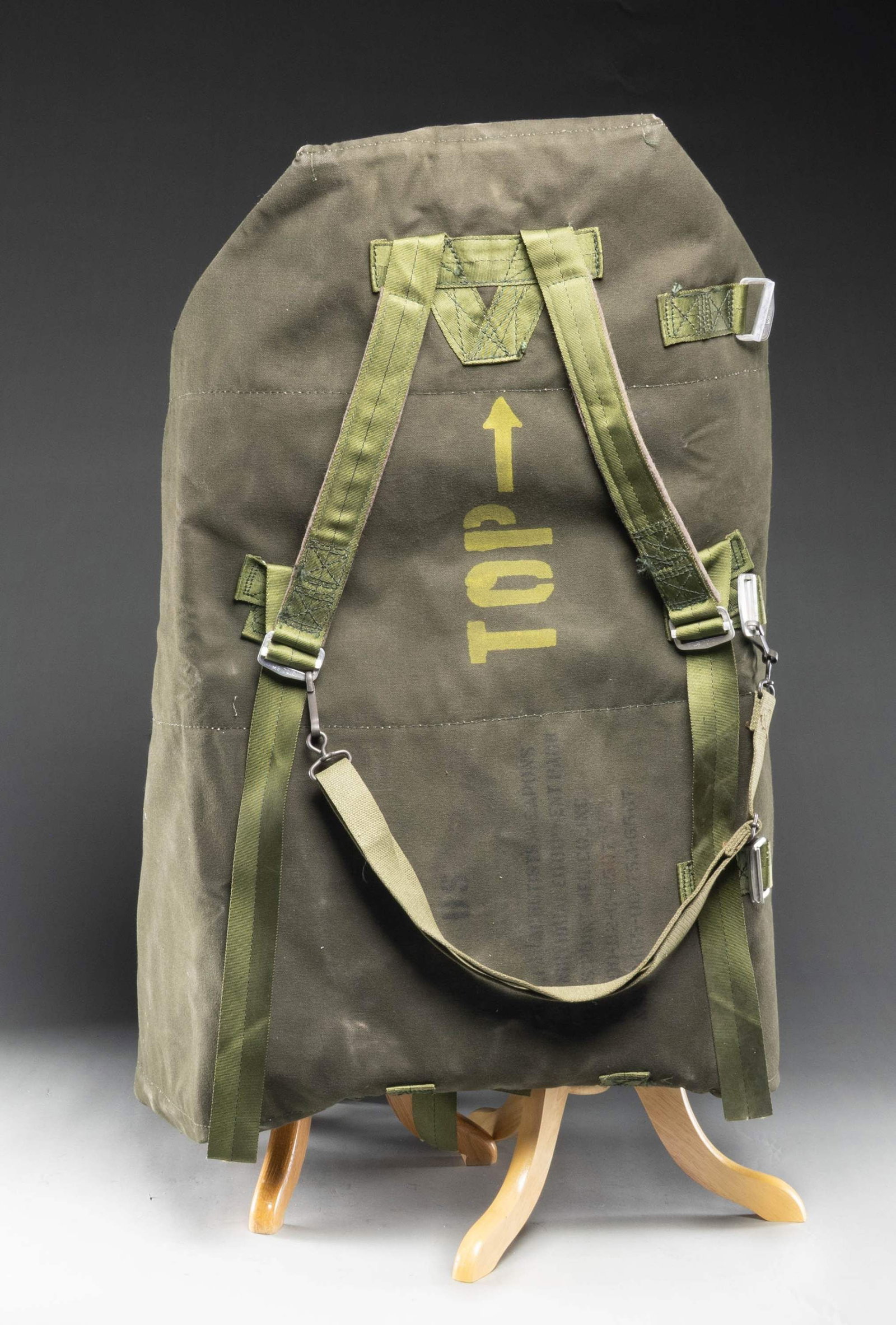US PARACHUTIST'S WEAPONS AND INDIVIDUAL EQUIPMENT: PACK. Large dark green canvas pack manufactured in the 1980s. Pack is marked "NSN 9465-00-753-65.17". Date on pack is "5/83". Pack has gray felt padding on the inside. Numerous nylon closure straps