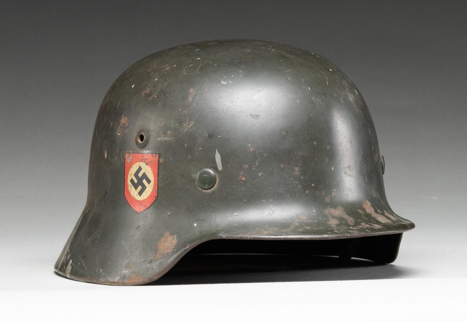 WWII GERMAN M35 POLICE HELMET.: WWII German M1935 Police double decal helmet having a dark green painted finish with a Police decal on the left side and a National decal on the right. The inside rear is stamped " D 142 " , and the