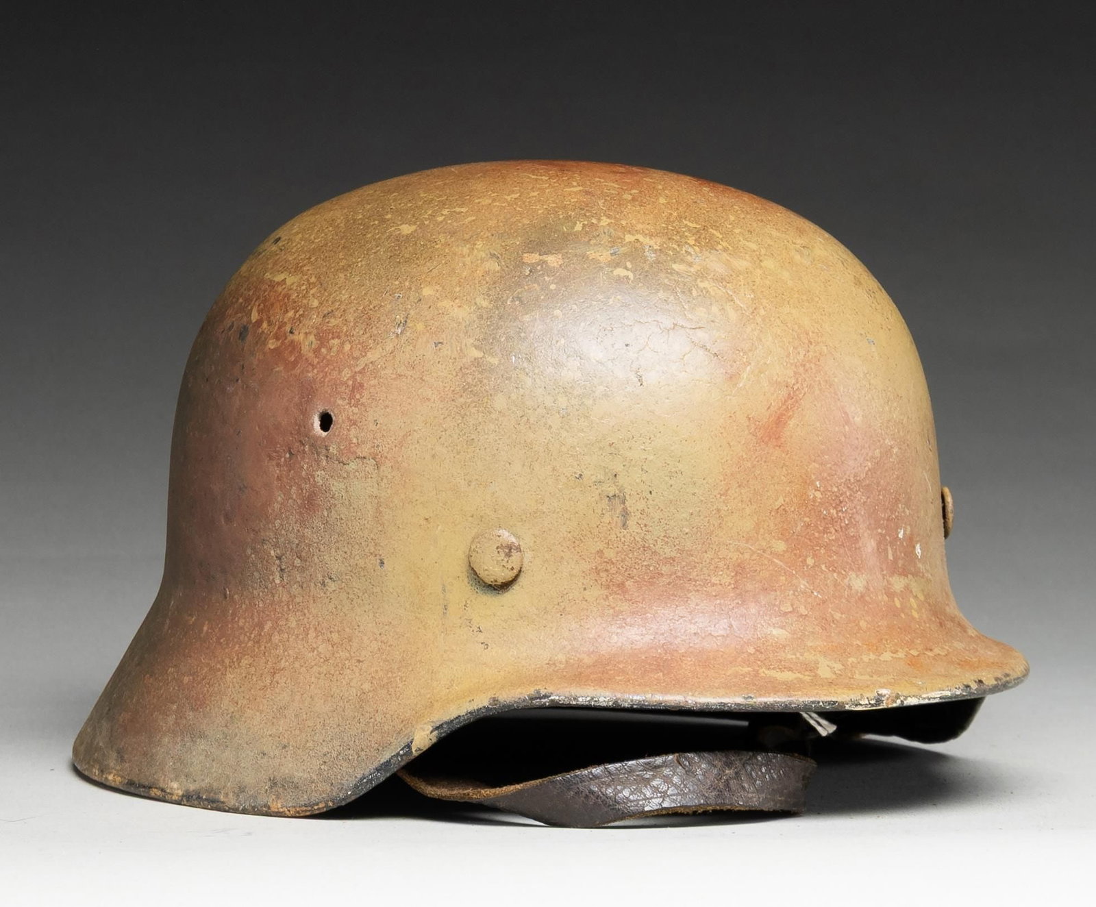 WWII GERMAN M40 CAMOUFLAGE HELMET.: WWII German Wehrmacht M1940 helmet with tan / red / olive paint on the exterior approximating " Normandy Camouflage " paint. The interior rear stamping is very hard to read but appears to read "17360"