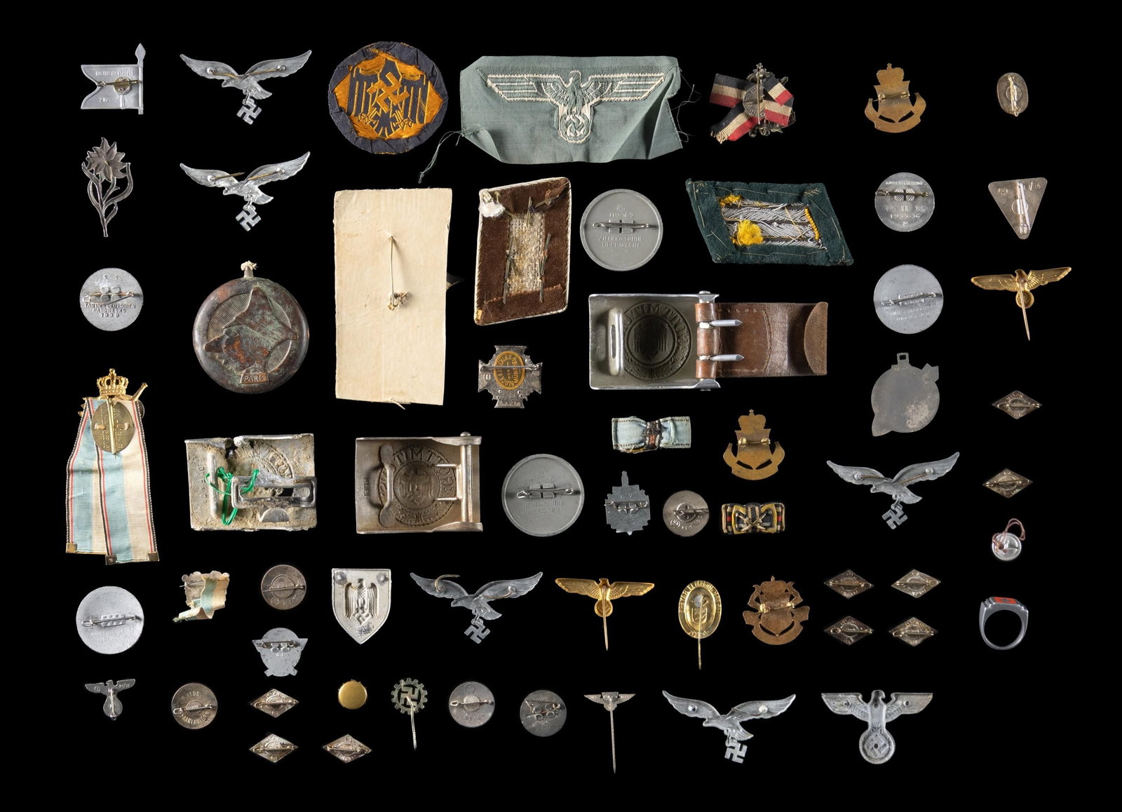 WWI & WWII GERMAN BUCKLES, PINS. EAGLES, AND MORE.: This varied lot includes 1 Political leader's collar tab, 1 Frauenwerk enamel pin, 9 Enameled HJ membership pins, 1 enameled RAD membership pin, 1 Aluminum ring with a central Party symbol, 2 Politica