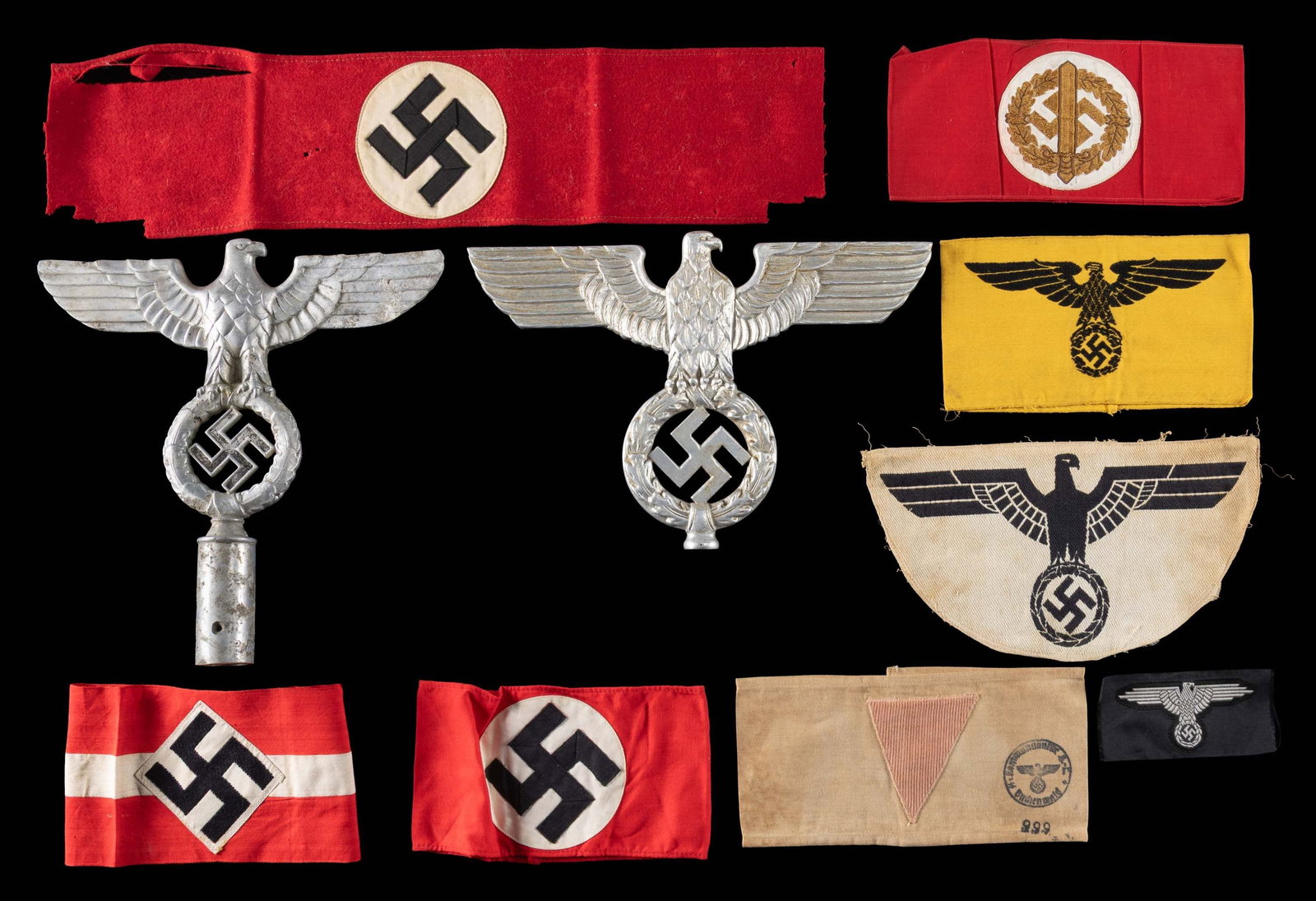 WWII GERMAN FLAG POLE TOPS AND CLOTH.: This WWII German group contains 1 Political flag pole top with socket in aluminum depicting an eagle on a wreath that surrounds a Party symbol, 1 Political flag pole top with out a socket in aluminum 
