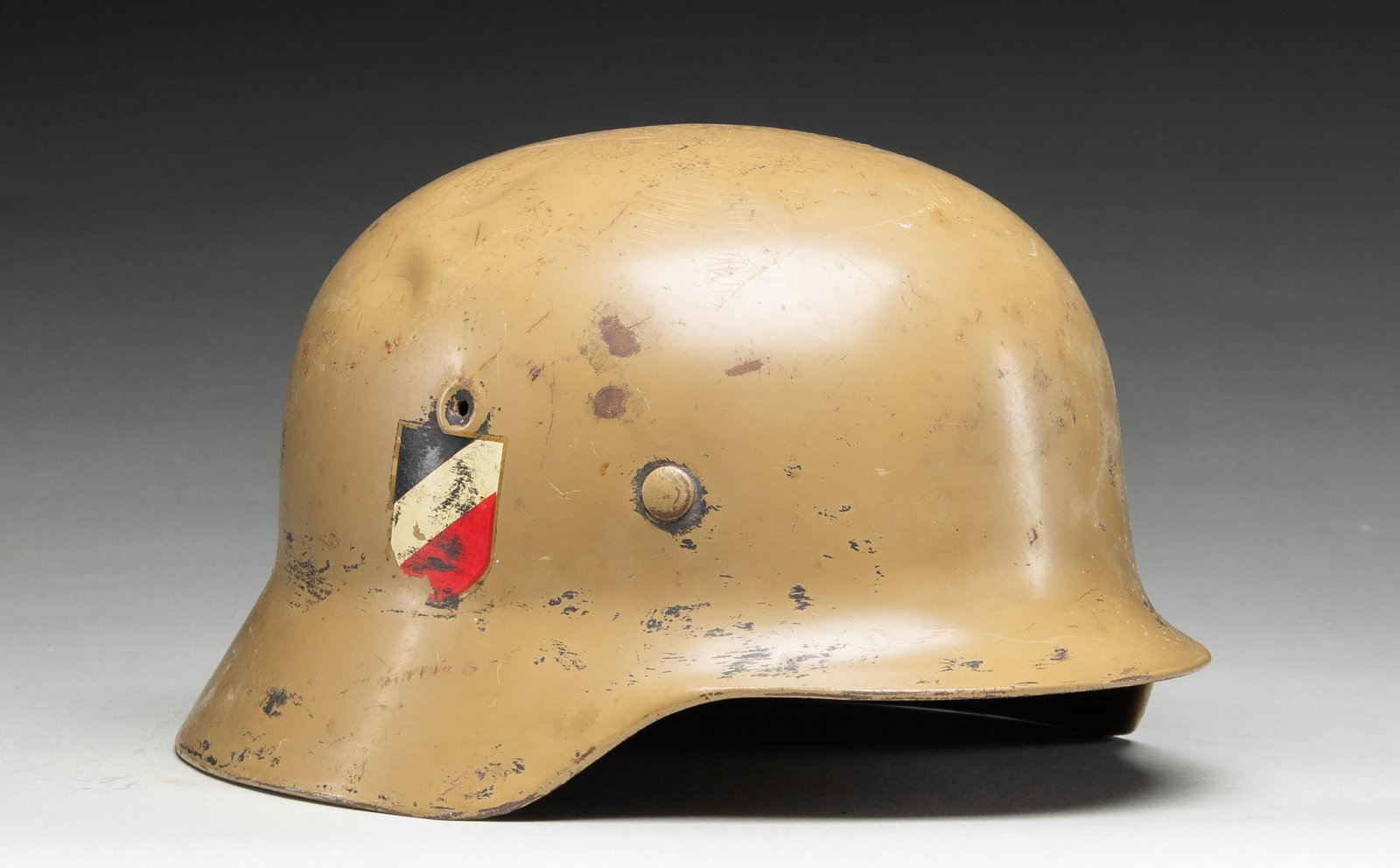 WWII GERMAN STYLE M40 AFRIKA KORPS HELMET.: WWII Style German M1940 tan camouflage Afrika Korps helmet having a tan painted finish and an Afrika Korps decal on the left side with a National colors decal on the right. No stampings are visible on