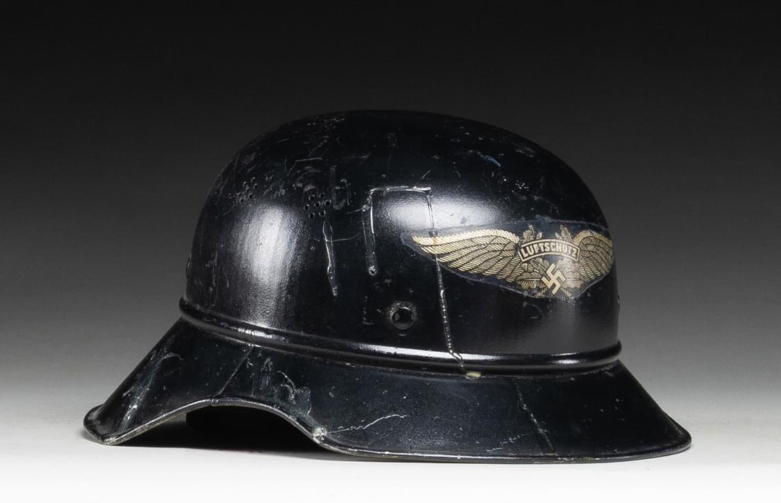 WWII GERMAN LUFTSCHUTZ GLADIATOR STYLE HELMET.: WWII German Luftschutz gladiator style helmet with a black repainted exterior finish and a post war applied decal. The interior has the original dark blue finish and the decal markings on the interior