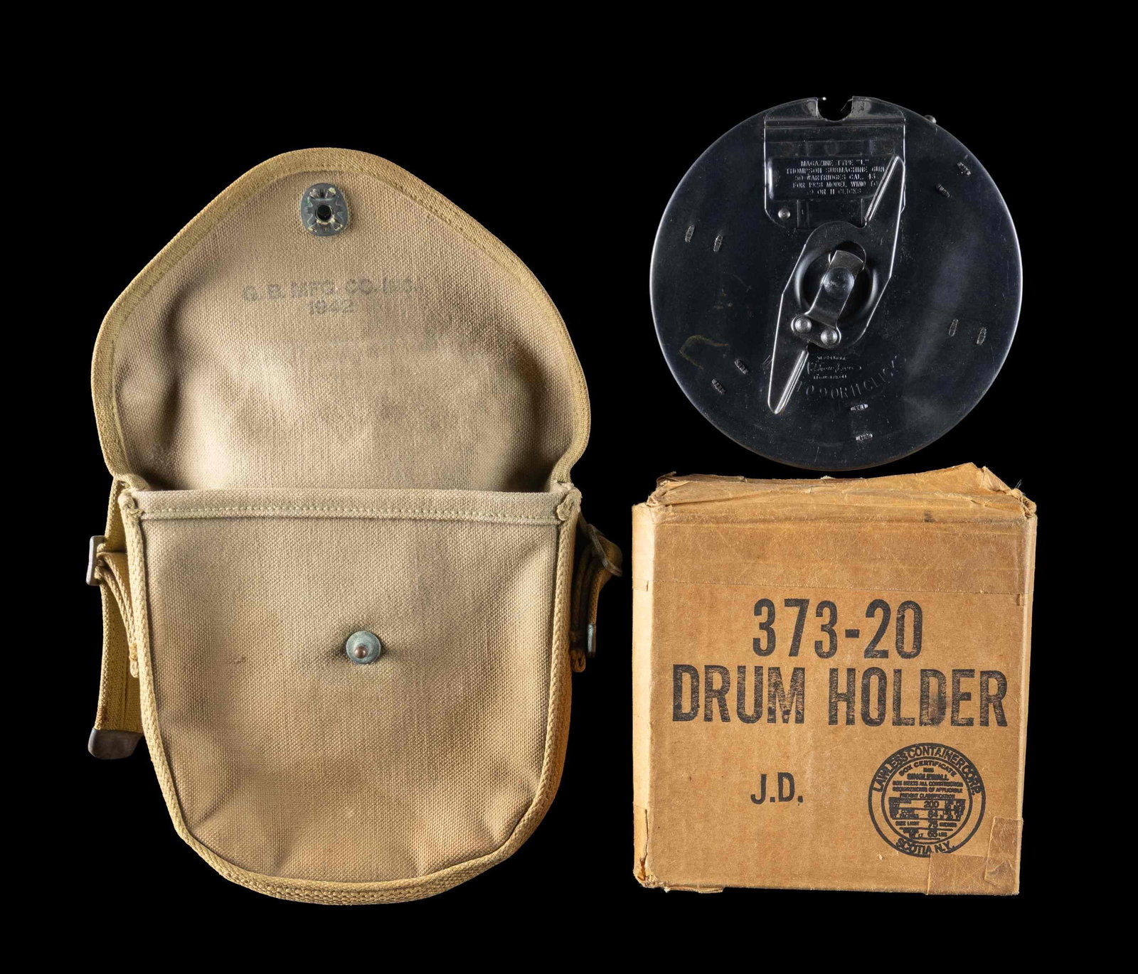 THOMPSON 50-ROUND "L" DRUM WITH BOX & CANVAS: CARRIER. Thompson submachine gun 50-rd. "L" drum mfg. by Auto-Ordnance Corp. Front data plate is marked "MAGAZINE TYPE "L"/ THOMPSON SUBMACHINE GUN/ 50 CARTRIDGES CAL. 45/ FOR 1928 MODEL WIND TO/ 9