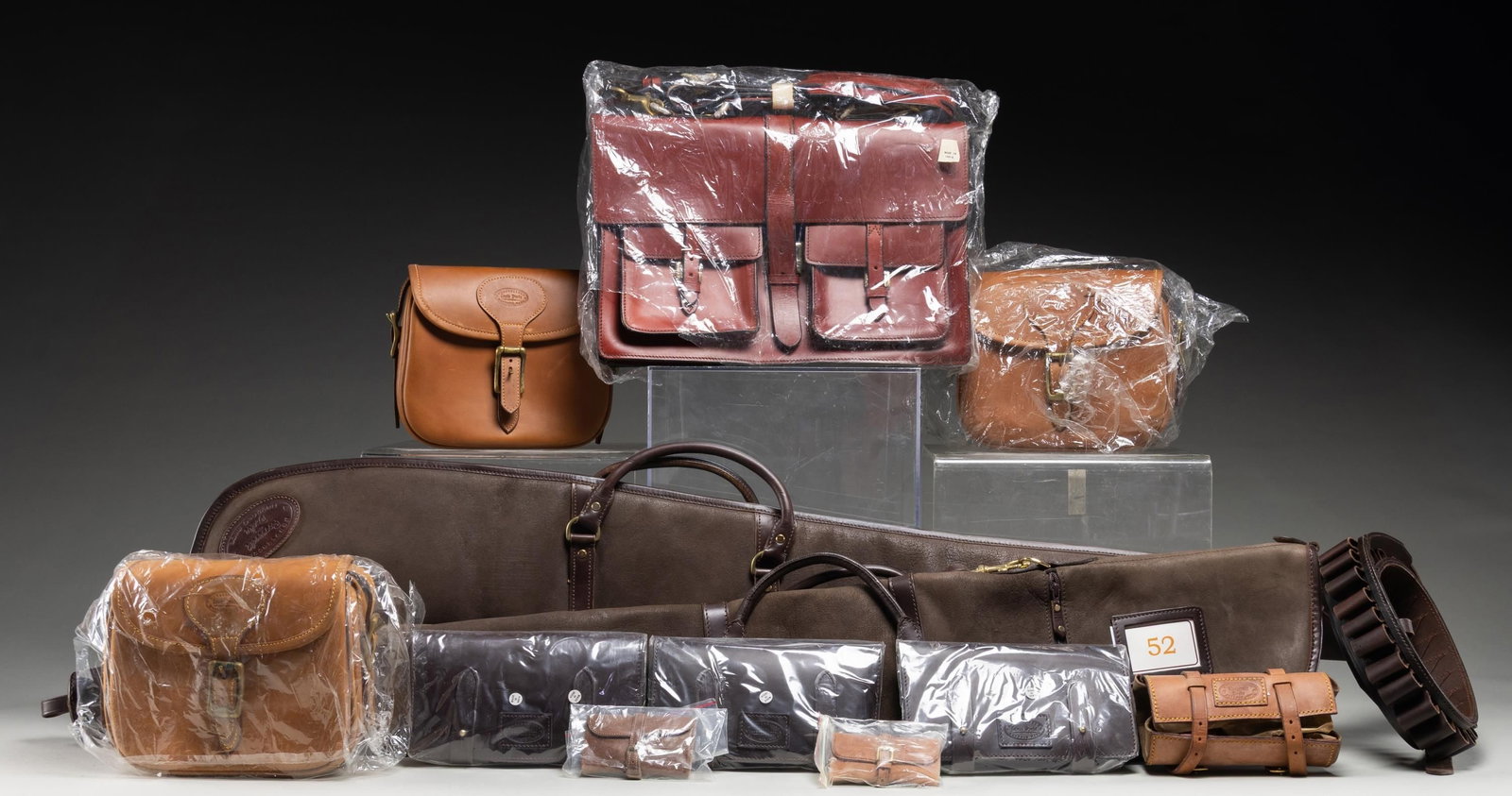GROUP OF LEWIS DRAKE GUN ACCESSORIES.: Lot includes zippered rifle cases, bags of various sizes, roll up pouch, cartridge loop belt & bore snakes retailed by Lewis Drake or Roosevelt & Drake. All items appear to be handmade from India. CON