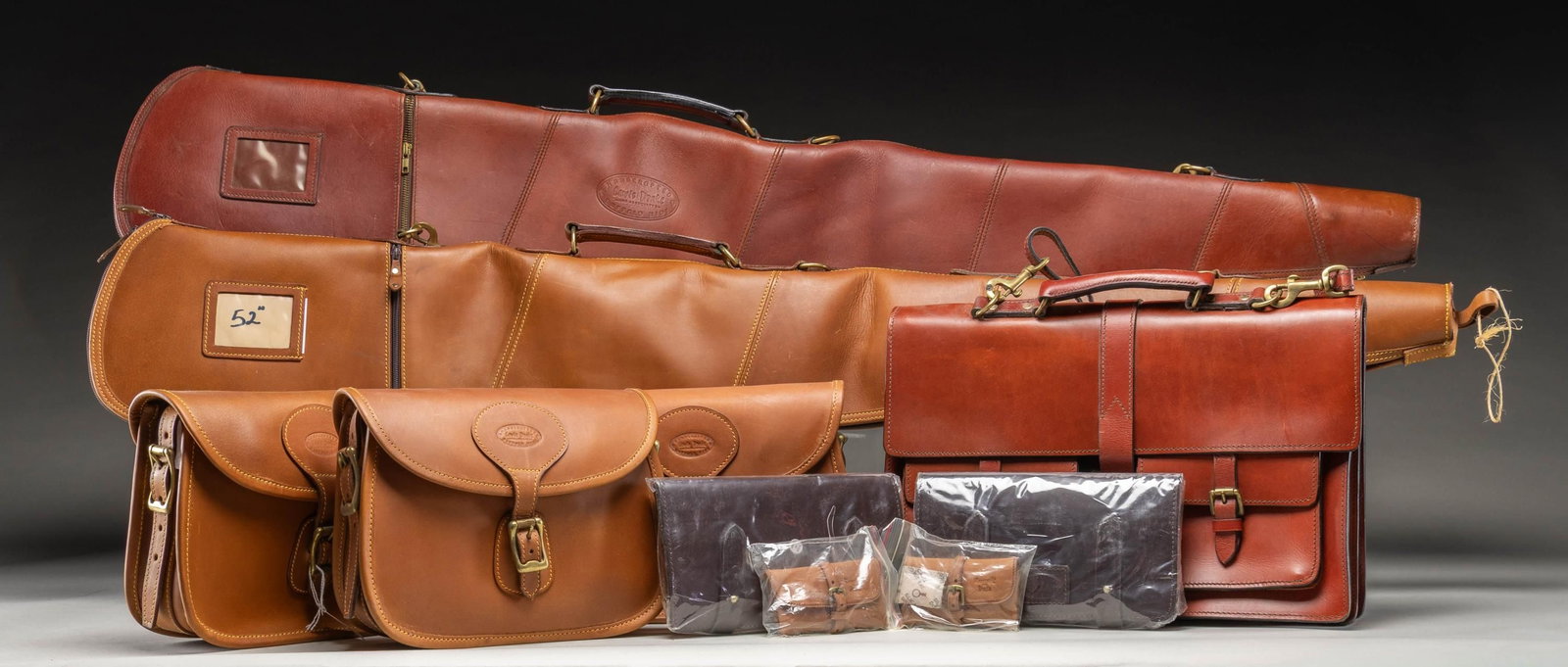 GROUP OF LEWIS DRAKE GUN ACCESSORIES.: Lot includes 2 zippered rifle cases, 6 bags of various sizes & 2 bore snake in pouches retailed by Lewis Drake or Roosevelt & Drake. All items appear to be handmade from India. CONDITION: items appear