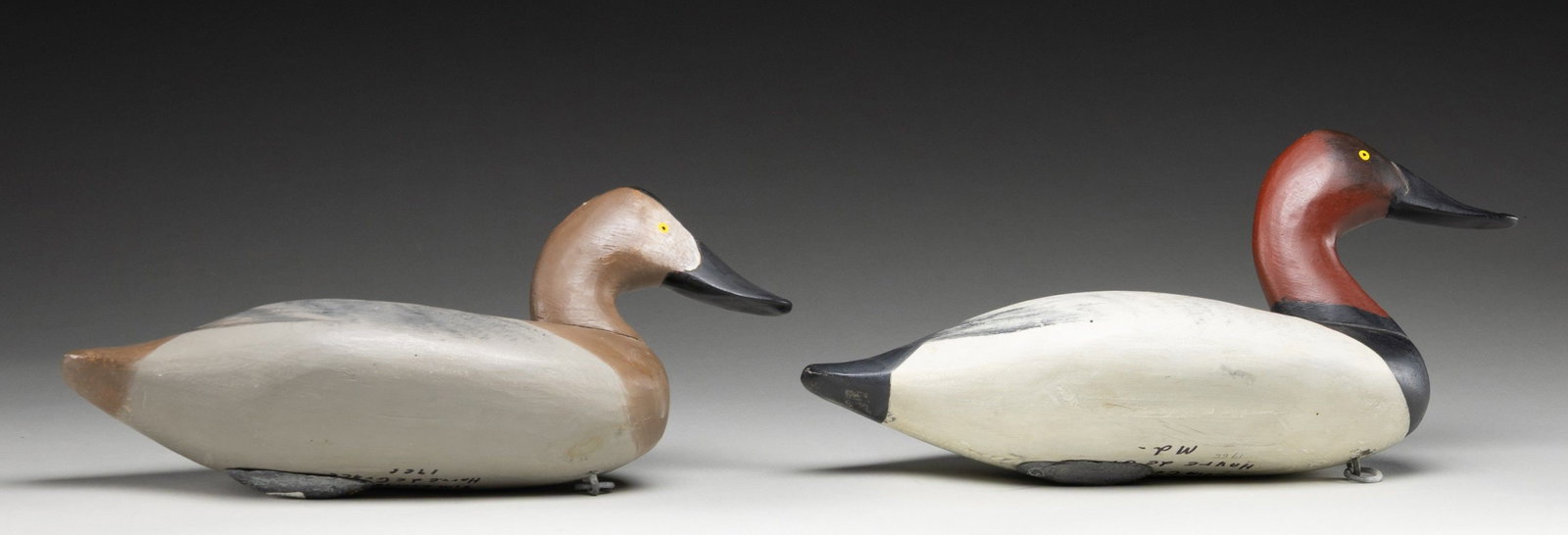 PAIR OF JIM CURRIER OF HAVRE DE GRACE, MD 1966: DATED CANVASBACK DECOYS. Overall: approx. 17" w/ 8" in height. CONDITION: very good overall showing dings & light fading. (02-26787/MD). NON-GUN. $200-300.