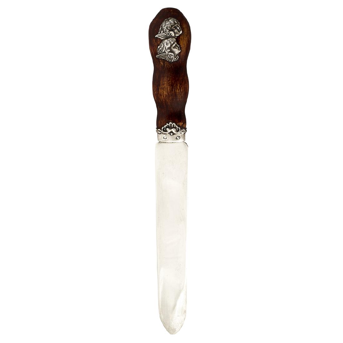 Possibly retailed by Benjamin & Ford paper knife: Maker Unknown, possibly retailed by Benjamin & Ford paper knife, #692 USA sterling silver, mahogany stained wood stamped marks winged putti head decoration 12 3/8"l x 1 3/8"d x 1"h