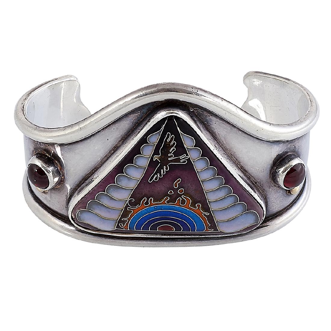 Colette Denton enameled Sun Eagle cuff bracelet: Colette Denton (b. 1937) Sun Eagle cuff bracelet Berkeley, California, 1977 sterling silver, cloisonné enamel, garnets inscribed marks 2 1/2"w x 1 1/2"d x 1 9/16"h Provenance: The Paul & Terry Somers