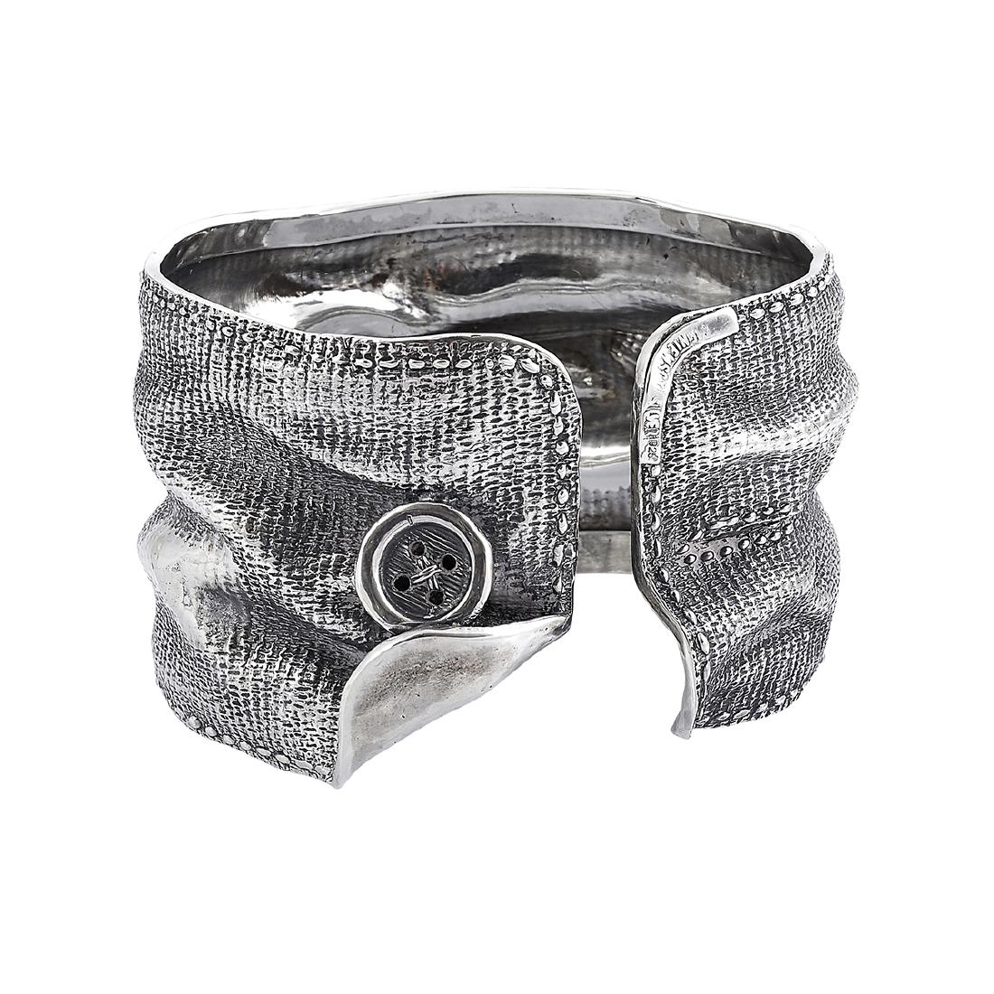 Marek & Lucyna Nieniewscy silver cuff bracelet: Marek and Lucyna Nieniewscy cuff bracelet Poland .925 silver stamped marks designed as realistic folded fabric and a button opening: 2 11/16"w x 2 3/8"h Provenance: The Paul & Terry Somerson Collectio