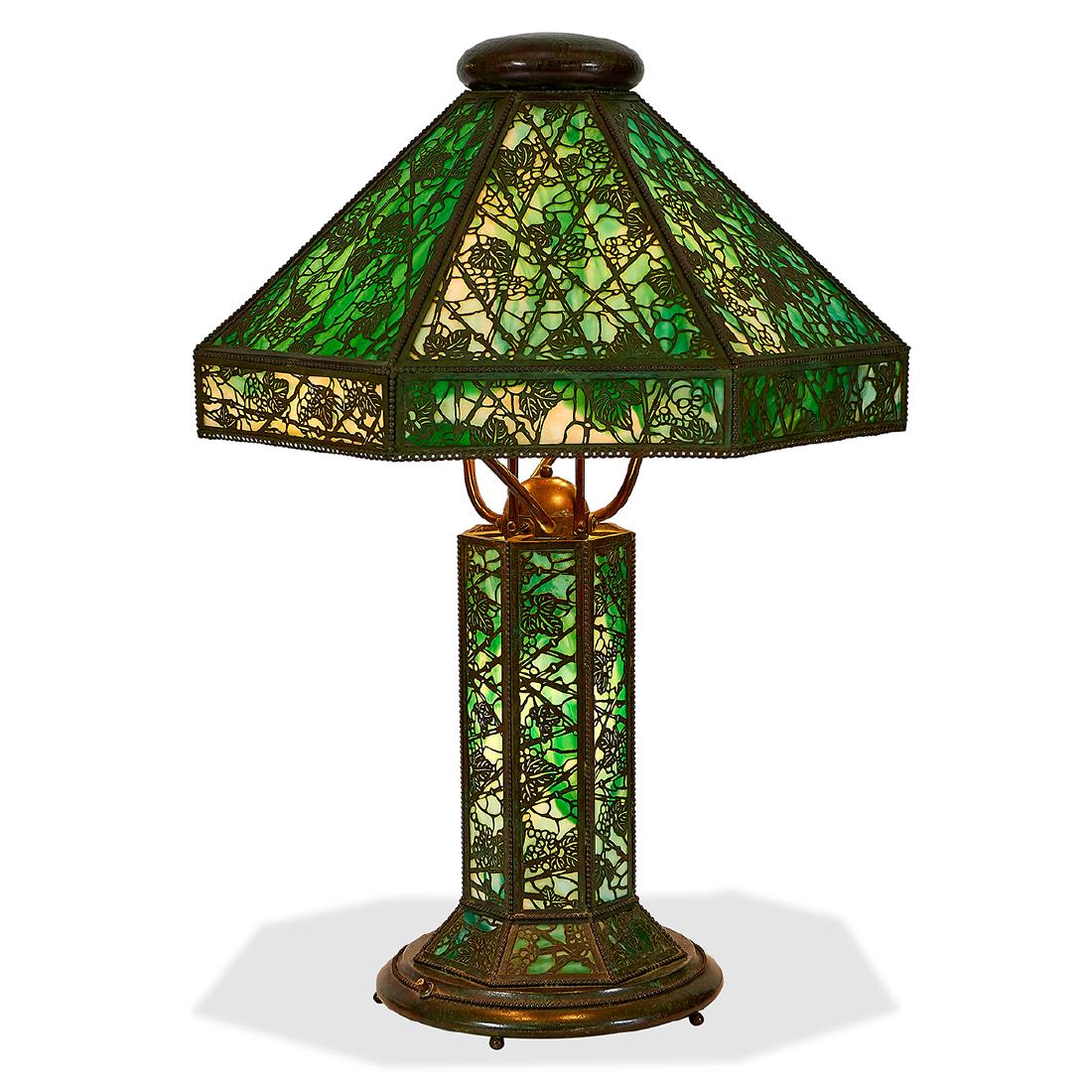 Riviere Studios table lamp: Riviere Studios table lamp New York, New York patinated bronzed metal, slag glass base with impressed mark 20"dia x 29 1/2"h Literature: A similar shade can be seen in: Crist, Paul, Mosaic Shades Volu