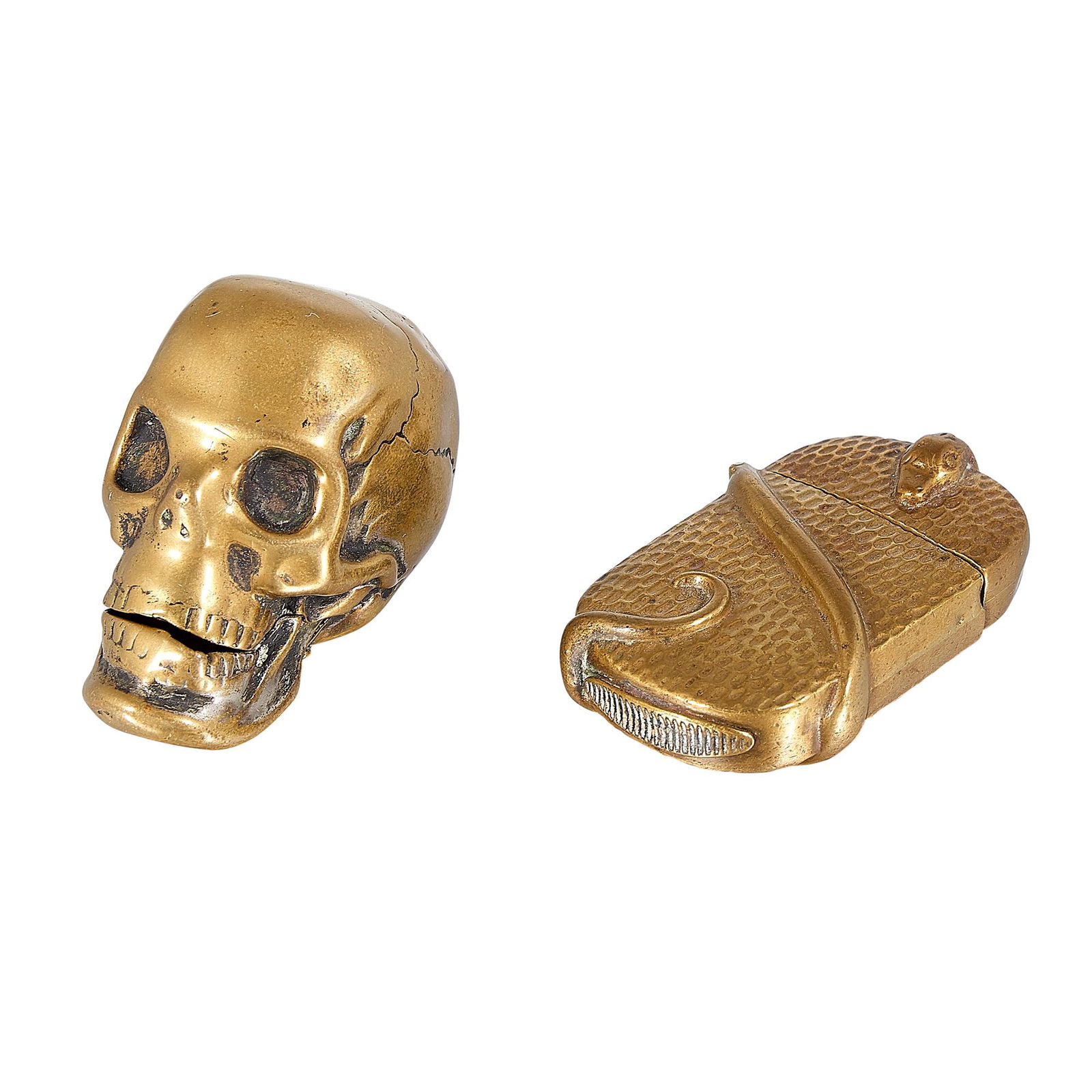 Figural skull-form match safe / vesta: Figural skull-form match safe / vesta brass unmarked together with a serpent motif example in brass first: 1"w x 1 7/8"d x 1 1/2"h Provenance: Property from the Collection of Governor Jim Thompson, Ch