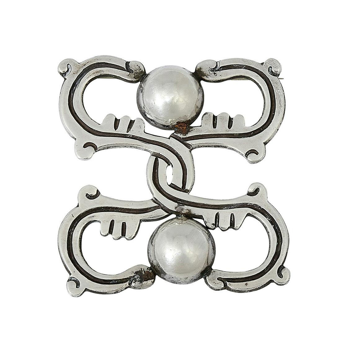 Artemio Navarrette Brooch: Artemio Navarrette brooch with intertwined motif and domed accents Taxco, Mexico .980 silver stamped marks 14.2 dwts 2"sq