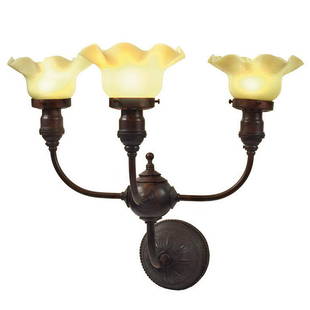 After Adler & Sullivan wall sconce: After Dankmar Adler & Louis Sullivan for the Guaranty Buildingthree-light wall sconceBuffalo, New Yorkcast iron, opaque Vaseline glassunmarked19"w x 15 1/2"d x 16"hLiterature:Taylor, Crombie, and