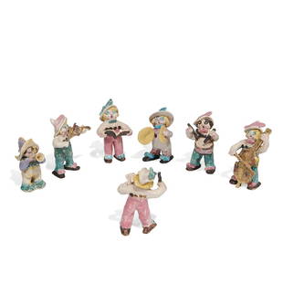 Overbeck Pottery group of figurines, seven: Overbeck Pottery group of earthenware figurines, seven, forming a band, each with a feathered hat Cambridge City, Indiana, circa 1940 high and matte glazed ceramic stamped or carved OBK mark Included