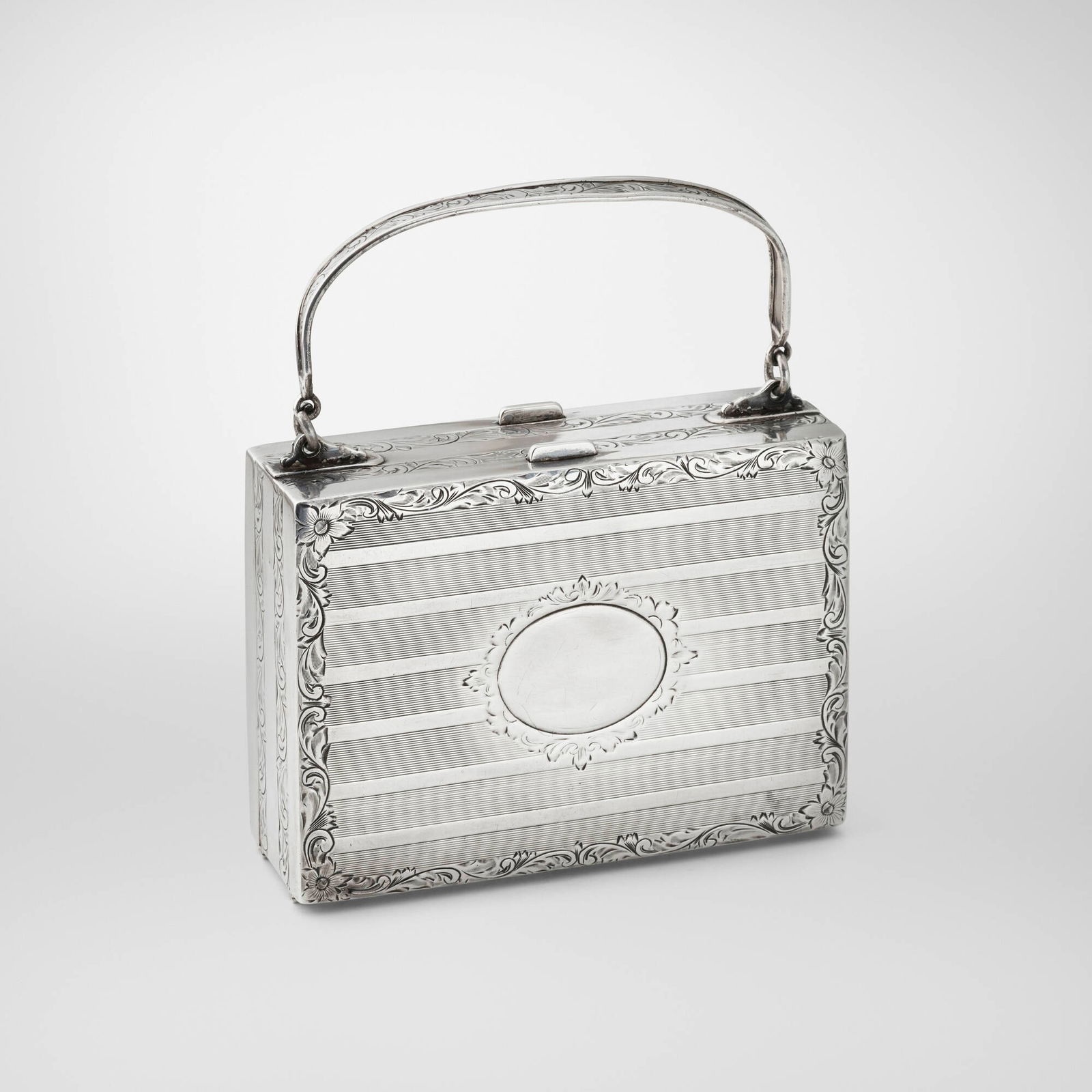 Gilded Age, Sterling silver makeup case: Gilded Age Sterling silver makeup case The engraved case opens on both sides to include a makeup compact, lipstick case, perfume flasks, nail file, shoe buttoner, small pouch, and business card from M