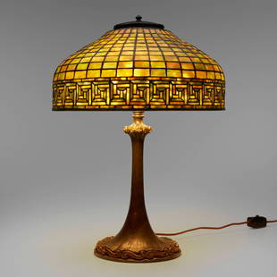 Tiffany Studios, Greek Key table lamp: Tiffany Studios Greek Key table lamp USA, c. 1910leaded glass, patinated and gilt bronze 21.75 h x 16 dia in (55 x 41 cm) Lamp features a Double Scroll (Wave) base.Impressed to shade 'T