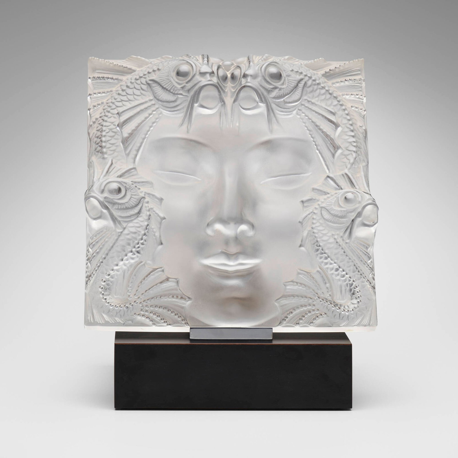 Lalique, Masque de femme plaque: Lalique Masque de femme plaque France, c. 1935 / 1945-1977 frosted glass 12.5 h x 12.5 w x 3.25 d in (32 x 32 x 8 cm) Etched manufacturer's mark to lower right 'Lalique France'. Sold with assoc